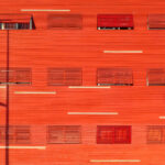 "Adalberto Dias's Agra do Casto Residential Complex at the University of Aveiro showcasing a modern design with vibrant red and orange elements."