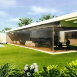 Alcino Soutinho's 14 Villas at Bom Sucesso Resort showcasing modern architecture with a sleek outdoor structure, landscaped garden, and artificial turf in the backyard.