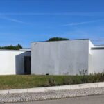 Álvaro Siza Vieira's 14 Villas at Bom Sucesso Resort showcasing modern architecture with concrete and plaster elements, featuring composite materials and thoughtful landscaping for daylighting and shade.