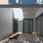 Álvaro Siza Vieira's 14 Villas at Bom Sucesso Resort showcasing a modern design with grey concrete walls, composite materials, and large daylighting windows.