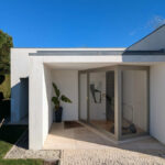Álvaro Siza Vieira's 14 Villas at Bom Sucesso Resort showcasing modern architecture with grey concrete walls, composite materials, and a prominent home door.