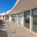 Álvaro Siza Vieira's Commercial Area at Bom Sucesso Resort showcasing a modern concrete structure with extensive daylighting and a sleek headquarters design.