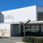 Álvaro Siza Vieira's Commercial Area at Bom Sucesso Resort showcasing a modern design with concrete and composite materials, featuring daylighting elements and shaded areas.