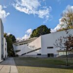 Álvaro Siza Vieira's Faculty of Architecture of the University of Porto showcases a modern design with concrete structures, integrated walkways, and strategic daylighting on a sloped site.
