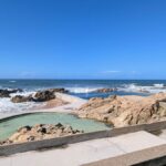 Álvaro Siza Vieira's Leça da Palmeira Seafront Avenue Urban Plan showcasing a coastal landscape with a rocky shoreline, expansive ocean views, and a horizon line blending with the sea.