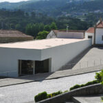 Álvaro Siza Vieira's Museum of International Contemporary Sculpture showcasing a concrete structure with composite material walls and a sloped design.