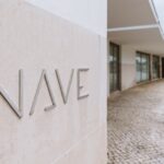 Álvaro Siza Vieira's Nave Lagoa - Event Space at Bom Sucesso Resort showcasing a modern interior design with a unique ceiling structure that enhances daylighting within the headquarters.