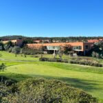 Carrilho da Graça's 14 Houses at Quinta do Bom Sucesso Resort showcasing modern architecture with a minimalist design, surrounded by expansive grassland and meticulously landscaped lawns.
