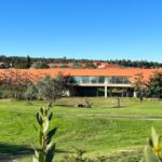 Carrilho da Graça's 14 Houses at Quinta do Bom Sucesso Resort showcasing modern architecture with a focus on integration into the landscape, featuring expansive lawns and meticulously designed gardens.