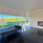 Carrilho da Graça's 14 Houses at Quinta do Bom Sucesso Resort showcasing modern design with wood flooring, daylighting, and a sleek tile finish.