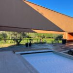 Carrilho da Graça's 14 Houses at Quinta do Bom Sucesso Resort showcasing modern architecture with concrete structures, wood stain finishes, and integrated landscaping for natural daylighting.