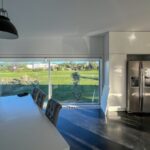 Carrilho da Graça's 14 Houses at Quinta do Bom Sucesso Resort showcasing a modern interior design with wood flooring, stylish furniture, and elegant lighting.