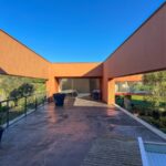 Carrilho da Graça's 14 Houses at Quinta do Bom Sucesso Resort showcasing modern architecture with concrete structures, integrated landscaping, and a central courtyard designed for optimal daylighting and shade.