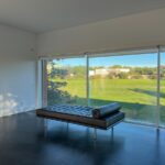 Carrilho da Graça's 14 Houses at Quinta do Bom Sucesso Resort showcasing modern architecture with hardwood flooring, ample daylighting, and shaded areas.