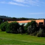 Carrilho da Graça's 14 Houses at Quinta do Bom Sucesso Resort showcasing modern architecture with a minimalist design, surrounded by landscaped lawns and open grassland.