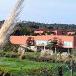 Carrilho da Graça's 14 Houses at Quinta do Bom Sucesso Resort showcasing modern landscaping with sleek, minimalist structures integrated into the natural environment.