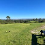 Donald Steel's design of the Bom Sucesso Resort Golf Course showcasing expansive grasslands and meticulously maintained fairways set against a backdrop of lush meadows.