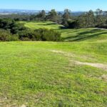 Donald Steel's design of the Bom Sucesso Resort Golf Course showcasing lush green grassland, expansive landscape, and meticulously maintained fairways.