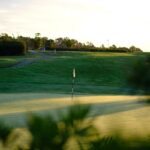 Donald Steel's Bom Sucesso Resort Golf Course showcasing expansive grass fields, meticulously maintained fairways, and a scenic landscape designed for optimal golfing experience.