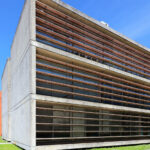Eduardo Souto de Moura's Department of Geo-sciences at the University of Aveiro showcasing a modern commercial building with concrete and composite materials, featuring daylighting elements and engineering precision.