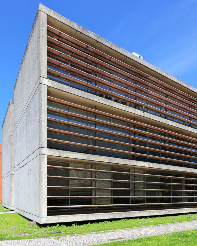 Eduardo Souto de Moura's Department of Geo-sciences at the University of Aveiro showcasing a modern silver exterior with adjacent parking facilities.