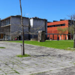 Eduardo Souto de Moura's Department of Geo-sciences at the University of Aveiro showcasing a modern concrete structure with composite materials, shaded walkways, and a public space on the campus.