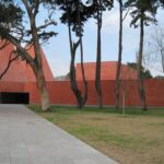 Eduardo Souto de Moura's House of Stories Paula Rego showcasing a modern design with composite material and concrete elements, highlighted by the interplay of shade and shadow.