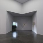 Eduardo Souto de Moura's House of Stories Paula Rego showcasing a triangular ceiling design with grey tones, emphasizing daylighting and transparency.