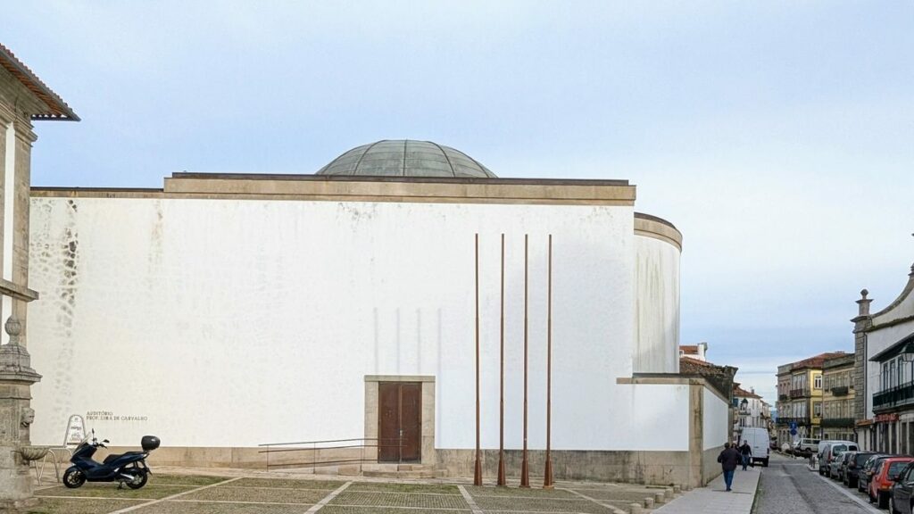 Fernando Távora's Amphitheater and Auxiliary Facilities of the Polytechnic Institute showcasing a concrete structure with a prominent dome and composite material walls, designed to enhance daylighting.