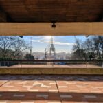 Fernando Távora's Tennis Pavilion of Quinta da Conceição showcasing a blend of hardwood flooring and composite materials with daylighting enhancing the shaded walkway.