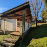 Fernando Távora's Tennis Pavilion of Quinta da Conceição showcasing a wooden structure with composite materials, daylighting features, and landscaping elements.