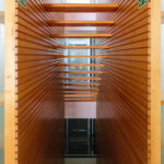 Gonçalo Byrne's Urban Requalification of São Martinho do Porto showcasing a modern interior with wood flooring, hardwood elements, composite materials, and a glass ceiling.