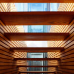 Gonçalo Byrne's Urban Requalification of São Martinho do Porto showcasing a symmetrical design with wood elements, including hardwood planks and a varnished ceiling.