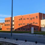 Jorge Kol de Carvalho's Department of Communication and Arts, University of Aveiro, showcasing a modern facade with urban design elements, street lights, and a campus driveway.