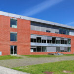 Jorge Kol de Carvalho's Department of Communication and Arts at the University of Aveiro showcasing a modern engineering design with a sleek glass façade and corporate headquarters aesthetic.