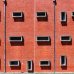 Jorge Kol de Carvalho's Department of Communication and Arts at the University of Aveiro showcasing a brick and composite material façade with daylighting elements.