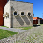 Jorge Kol de Carvalho's Department of Communication and Arts, University of Aveiro, showcasing a symmetrical design with composite materials, brickwork, concrete, and tile elements.