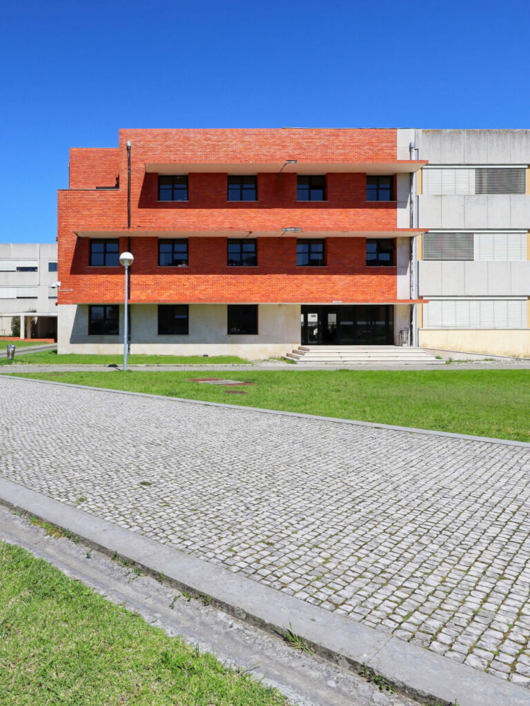 José Maria Lopo Prata's Department of Education, University of Aveiro interior showcasing modern furniture with leather chairs, armrests, and a daybed in a spacious waiting room with sleek flooring.