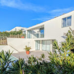 Josep Llinás's 6 Villas at Bom Sucesso Resort showcasing modern residential design with landscaped surroundings, palm trees, and balconies.