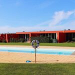 Luís Pessanha Moreira's 27 Row Houses at Bom Sucesso Resort showcasing a modern design with a swimming pool, leisure areas, shaded walkways, and eco-friendly features.