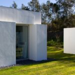 Manuel Aires Mateus's 7 Row Houses at Bom Sucesso Resort showcasing a modern design with concrete structures, composite materials, and landscaped surroundings.