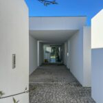 Manuel Aires Mateus's 7 Row Houses at Bom Sucesso Resort showcasing a minimalist design with concrete structures and ample daylighting.