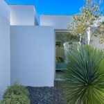 Manuel Aires Mateus's 7 Row Houses at Bom Sucesso Resort showcasing a modern design with integrated landscaping and ample daylighting through large windows.
