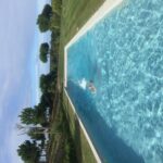 Manuel Aires Mateus's 7 Row Houses at Bom Sucesso Resort showcasing a modern design with a swimming pool, landscaped garden, and water feature integrated into the leisure-focused resort environment.