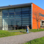 Manuel Aires Mateus and Francisco Aires Mateus' "Canteen and Dining Halls, University of Aveiro" showcasing a modern design with composite materials, large glass façades, and strategic daylighting elements.