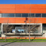 Manuel Aires Mateus and Francisco Aires Mateus' "Canteen and Dining Halls, University of Aveiro" showcasing a modern facade with composite materials and urban design elements, featuring daylighting and shaded areas.