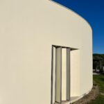 Manuel Graça Dias and Egas José Vieira's 13 Round Houses at Bom Sucesso Resort showcasing composite material and concrete structures with effective daylighting and shadow play.