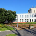 Maria Emília Pedroso Lima's design of the Higher Institute of Accounting and Administration, University of Aveiro, showcasing a modern campus setting with palm trees and residential-style buildings.