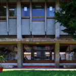 Noémia de Azevedo Coutinho's Conservatório de Música de Aveiro Calouste Gulbenkian showcasing Brutalist architecture with concrete structures, a central courtyard, and daylighting elements surrounded by a well-maintained lawn.