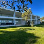 Nuno Graça Moura's 24 Row Houses at Bom Sucesso Resort showcasing modern landscaping with sleek, minimalist design elements and integrated green spaces.